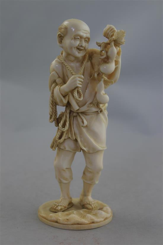 A Japanese ivory figure of a farmer, Meiji period, 16.5cm